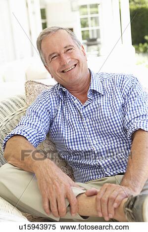 Stock Photography - Portrait Of Senior Man Relaxing In Chair. Fotosearch