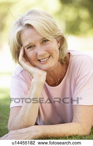 Stock Image - Portrait Of Senior Woman In Park. Fotosearch
