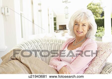 Stock Image - Portrait Of Senior Woman Relaxing In Chair. Fotosearch