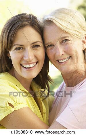 Stock Image - Portrait Of Senior Woman With Adult Daughter. Fotosearch