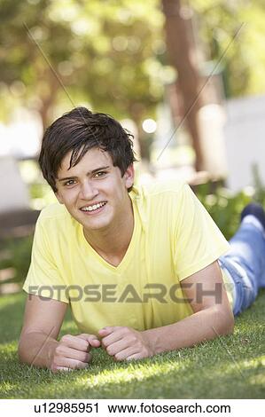 Portrait Of Teenage Boy Laying In Park View Large Photo Image Stock Image - Portrait Of Teenage Boy Laying In Park. Fotosearch