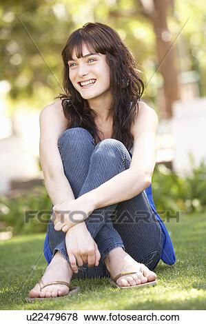 Portrait Of Teenage Girl Sitting In Park View Large Photo Image Stock Photo - Portrait Of Teenage Girl Sitting In Park. Fotosearch