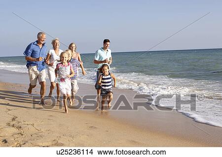 Picture - Portrait Of Three Generation Family On Beach Holiday. Fotosearch