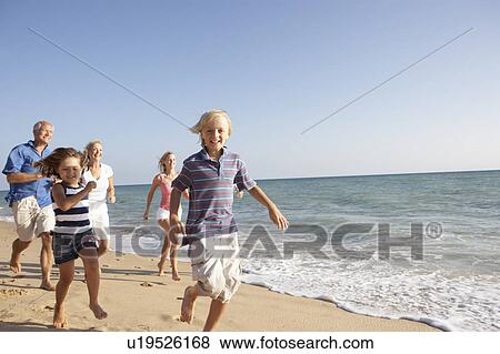 Stock Photo - Portrait Of Three Generation Family On Beach Holiday. Fotosearch