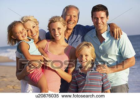 Stock Photography - Portrait Of Three Generation Family On Beach Holiday. Fotosearch