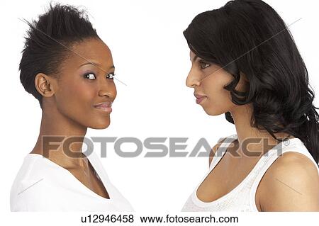 Stock Photo - Portrait Of Two Attractive Young Women In Studio. Fotosearch