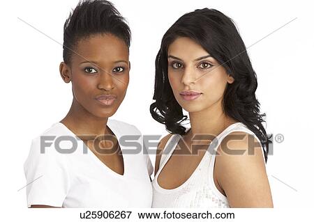 Stock Photo - Portrait Of Two Attractive Young Women In Studio. Fotosearch