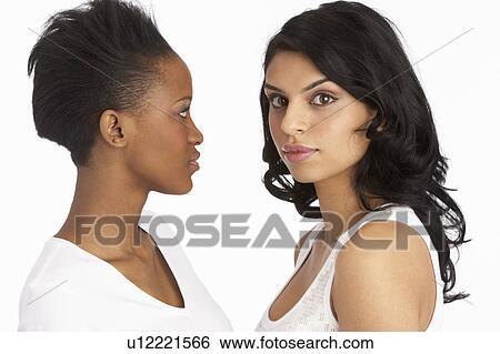 Stock Photograph - Portrait Of Two Attractive Young Women In Studio. Fotosearch