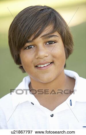 Stock Photo - Portrait Of Young Boy In Park. Fotosearch