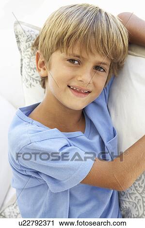 Portrait Of Young Boy Relaxing On Sofa View Large Photo Image Stock Image - Portrait Of Young Boy Relaxing On Sofa. Fotosearch