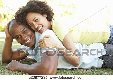Portrait Of Young Couple Laying On Grass In Park View Large Photo Image Stock Photography - Portrait Of Young Couple Laying On Grass In Park. Fotosearch