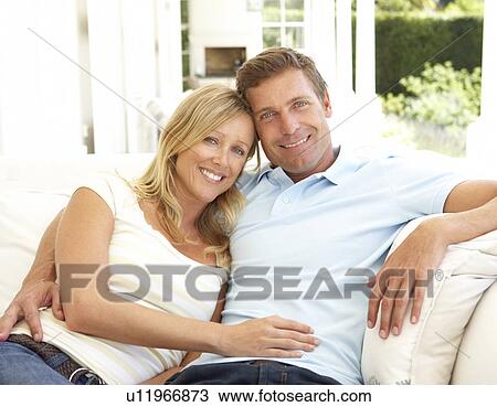 Portrait Of Young Couple Relaxing Together On Sofa View Large Photo Image Stock Image - Portrait Of Young Couple Relaxing Together On Sofa. Fotosearch