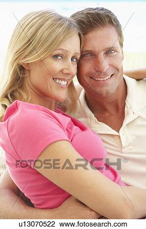 Portrait Of Young Couple Relaxing Together On Sofa View Large Photo Image Stock Image - Portrait Of Young Couple Relaxing Together On Sofa. Fotosearch
