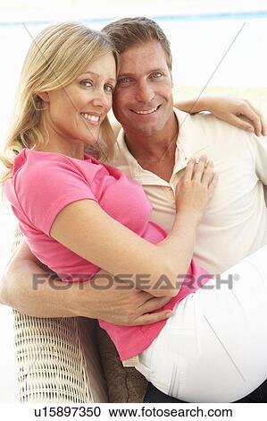 Portrait Of Young Couple Relaxing Together On Sofa View Large Photo Image Stock Image - Portrait Of Young Couple Relaxing Together On Sofa. Fotosearch