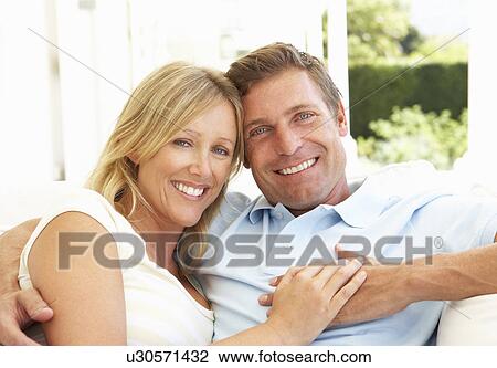 Portrait Of Young Couple Relaxing Together On Sofa View Large Photo Image Stock Image - Portrait Of Young Couple Relaxing Together On Sofa. Fotosearch
