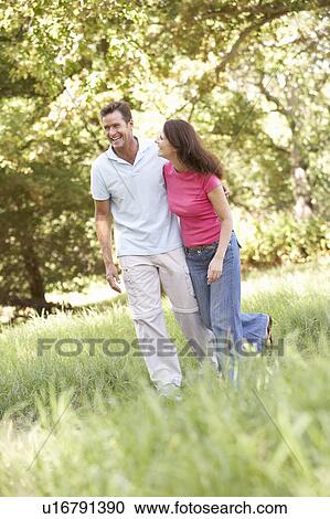 Portrait Of Young Couple Walking In Park View Large Photo Image Stock Image - Portrait Of Young Couple Walking In Park. Fotosearch