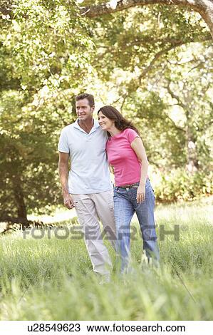Portrait Of Young Couple Walking In Park View Large Photo Image Stock Image - Portrait Of Young Couple Walking In Park. Fotosearch
