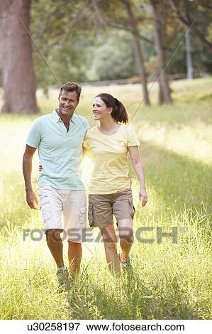 Portrait Of Young Couple Walking In Park View Large Photo Image Stock Photo - Portrait Of Young Couple Walking In Park. Fotosearch