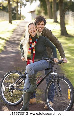 Portrait Of Young Couple With Cycle In Autumn Park View Large Photo Image Stock Image - Portrait Of Young Couple With Cycle In Autumn Park. Fotosearch