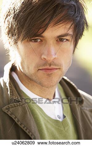 Stock Photo - Portrait Of Young Man In Autumn Park. Fotosearch