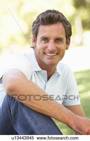Stock Photography - Portrait Of Young Man In Park. Fotosearch
