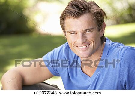 Portrait Of Young Man Relaxing In Park View Large Photo Image Stock Image - Portrait Of Young Man Relaxing In Park. Fotosearch