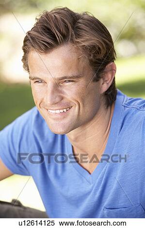 Portrait Of Young Man Relaxing In Park View Large Photo Image Stock Photography - Portrait Of Young Man Relaxing In Park. Fotosearch