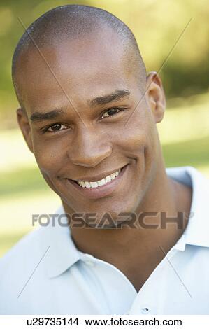 Portrait Of Young Man Sitting In Park View Large Photo Image Picture - Portrait Of Young Man Sitting In Park. Fotosearch