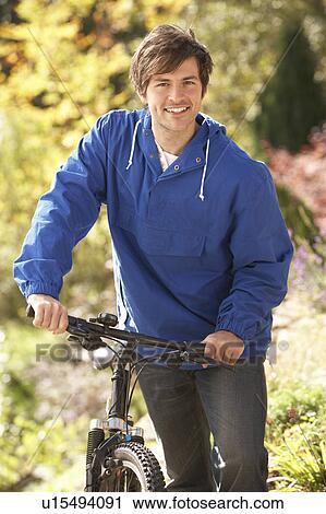 Portrait Of Young Man With Cycle In Autumn Park View Large Photo Image Stock Image - Portrait Of Young Man With Cycle In Autumn Park. Fotosearch