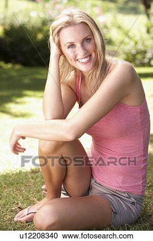 Portrait Of Young Woman Relaxing In Park View Large Photo Image Stock Image - Portrait Of Young Woman Relaxing In Park. Fotosearch