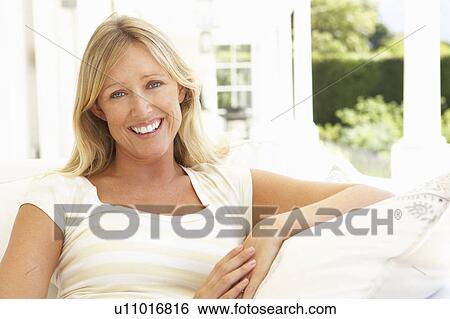 Portrait Of Young Woman Relaxing On Sofa View Large Photo Image Stock Photograph - Portrait Of Young Woman Relaxing On Sofa. Fotosearch