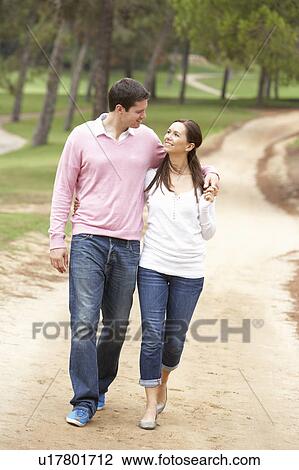 Stock Image - Romantic couple enjoying walk in park. Fotosearch