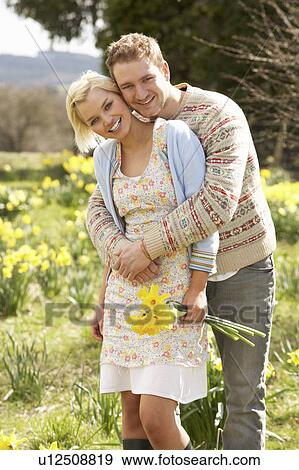 Romantic Couple Walking Amongst Spring Daffodils View Large Photo Image Stock Photo - Romantic Couple Walking Amongst Spring Daffodils. Fotosearch