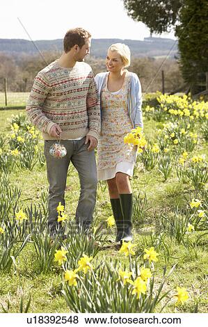 Stock Photo - Romantic Couple Walking Amongst Spring Daffodils. Fotosearch