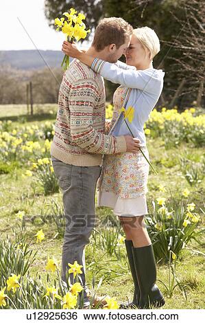 Romantic Couple Walking Amongst Spring Daffodils View Large Photo Image Stock Photograph - Romantic Couple Walking Amongst Spring Daffodils. Fotosearch
