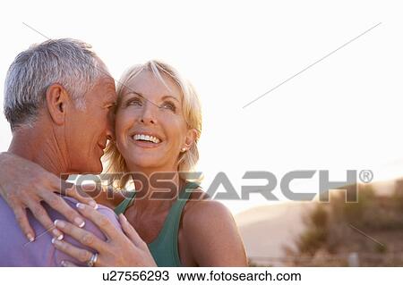 Stock Image - Romantic Senior Couple in love at sunset. Fotosearch