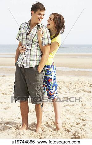 Romantic Teenage Couple Embracing On Beach View Large Photo Image Stock Photograph - Romantic Teenage Couple Embracing On Beach . Fotosearch