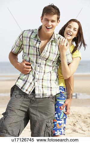 Romantic Teenage Couple Embracing On Beach View Large Photo Image Stock Photography - Romantic Teenage Couple Embracing On Beach . Fotosearch