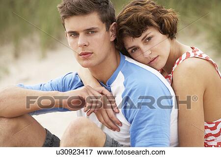 Stock Photo - Romantic Young Couple Embracing On Beach. Fotosearch