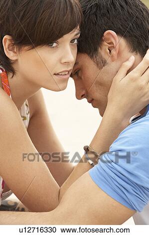 Romantic Young Couple Embracing On Beach View Large Photo Image Stock Image - Romantic Young Couple Embracing On Beach . Fotosearch