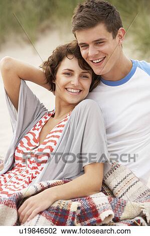 Stock Image - Romantic Young Couple Embracing On Beach . Fotosearch