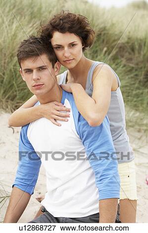 Romantic Young Couple Embracing On Beach View Large Photo Image Stock Photo - Romantic Young Couple Embracing On Beach . Fotosearch