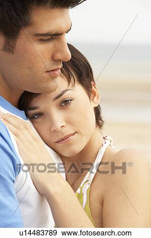 Romantic Young Couple Embracing On Beach View Large Photo Image Stock Photo - Romantic Young Couple Embracing On Beach . Fotosearch