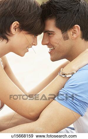 Romantic Young Couple Embracing On Beach View Large Photo Image Stock Photo - Romantic Young Couple Embracing On Beach . Fotosearch