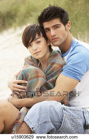 Stock Photo - Romantic Young Couple Embracing On Beach . Fotosearch