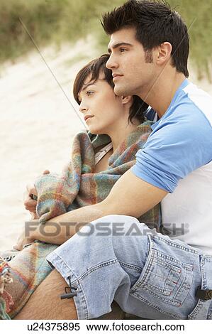 Stock Photography - Romantic Young Couple Embracing On Beach . Fotosearch