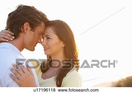 Stock Photo - Romantic Young couple in love at sunset. Fotosearch