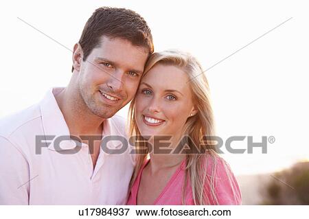 Romantic Young couple in love at sunset View Large Photo Image Stock Photo - Romantic Young couple in love at sunset. Fotosearch