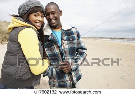 Stock Image - Romantic Young Couple On Winter Beach. Fotosearch