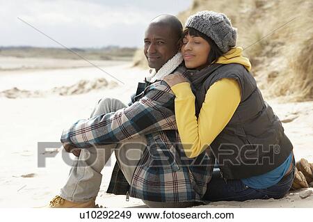 Romantic Young Couple On Winter Beach View Large Photo Image Stock Photo - Romantic Young Couple On Winter Beach. Fotosearch